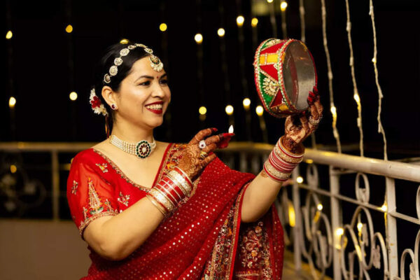 Why do women wear red clothes on Karwa Chauth?